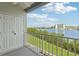 Exterior balcony view overlooking waterfront and lush landscaping with blue skies at 14800 Walsingham Rd # 1215, Largo, FL 33774