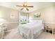 Cozy bedroom with natural light, ceiling fan and white furniture with an exterior view at 1626 Terra Ceia Bay Cir # 6, Palmetto, FL 34221