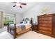 Comfortable bedroom featuring a wooden bed frame, chest of drawers and bright window at 1626 Terra Ceia Bay Cir # 6, Palmetto, FL 34221