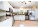 Bright kitchen with white cabinets, stainless steel appliances, and granite countertops and eat-in kitchen at 1626 Terra Ceia Bay Cir # 6, Palmetto, FL 34221