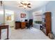 Bright home office featuring a large window, ceiling fan and desk with a view into the primary bathroom at 1626 Terra Ceia Bay Cir # 6, Palmetto, FL 34221
