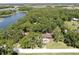 Scenic aerial view of a home nestled among trees with a lake nearby at 1753 Ranchette Rd, Wesley Chapel, FL 33543