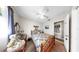 Bright bedroom with a tiled bathroom and wooden furniture with a patterned quilt at 1753 Ranchette Rd, Wesley Chapel, FL 33543