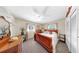 Comfortable bedroom with soft lighting, wooden furniture, and a ceiling fan, creating a cozy and inviting atmosphere at 1753 Ranchette Rd, Wesley Chapel, FL 33543