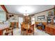 Charming dining area with wooden table and chairs, adjacent to kitchen and display cabinet, perfect for Gathering meals at 1753 Ranchette Rd, Wesley Chapel, FL 33543