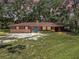 Charming single-story brick home with a well-maintained lawn and colorful flowerbeds at 1753 Ranchette Rd, Wesley Chapel, FL 33543