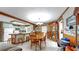 Open-concept kitchen connected to dining area, featuring retro green cabinets and a center island, great for entertaining at 1753 Ranchette Rd, Wesley Chapel, FL 33543