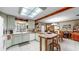 Spacious kitchen boasts retro green cabinets, a center island, and opens to a dining area, perfect for Gathering gatherings at 1753 Ranchette Rd, Wesley Chapel, FL 33543