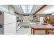 Quaint kitchen featuring retro green cabinets, a tile counter, and ample natural light, blending charm and functionality at 1753 Ranchette Rd, Wesley Chapel, FL 33543