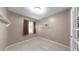 A bright empty room with tile flooring, neutral paint, a small window, and white trim at 1753 Ranchette Rd, Wesley Chapel, FL 33543