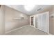 An empty room featuring neutral paint, tile flooring, and white trim around the windows and doors at 1753 Ranchette Rd, Wesley Chapel, FL 33543