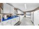 Large utility room with white cabinets, blue countertops, white appliances, and patterned floors at 1753 Ranchette Rd, Wesley Chapel, FL 33543