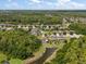 Aerial view showcasing the community, with mature trees and community pond at 19409 Wingrove Ln, Lutz, FL 33558