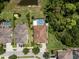 An aerial view of a home showing a screened in pool and lush back yard bordered by trees at 19409 Wingrove Ln, Lutz, FL 33558