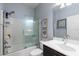 Bathroom featuring a glass-enclosed shower, white subway tile, and modern fixtures at 19409 Wingrove Ln, Lutz, FL 33558
