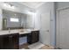 Luxurious bathroom with dual vanities, a makeup area, and a separate bathtub at 19409 Wingrove Ln, Lutz, FL 33558