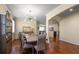 Elegant dining room with hardwood floors, stylish chandelier, and an open layout with views to the living areas at 19409 Wingrove Ln, Lutz, FL 33558
