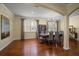 Formal dining room featuring hardwood floors, modern lighting, and large windows with shutter style shades at 19409 Wingrove Ln, Lutz, FL 33558