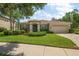Charming single-story home featuring a lush lawn, manicured landscaping, and a welcoming two-car garage at 19409 Wingrove Ln, Lutz, FL 33558