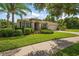Lovely single-story home boasts a well-maintained lawn, tidy landscaping, and a serene neighborhood setting at 19409 Wingrove Ln, Lutz, FL 33558