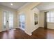 Elegant entryway boasts hardwood floors, decorative glass door, and a view into the adjacent sitting area at 19409 Wingrove Ln, Lutz, FL 33558