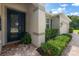 Inviting entryway featuring a stylish front door, lush landscaping, and a paver walkway leading to the home at 19409 Wingrove Ln, Lutz, FL 33558