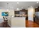 Modern kitchen with stainless appliances, breakfast bar, granite countertops, and hardwood flooring at 19409 Wingrove Ln, Lutz, FL 33558