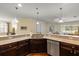 Spacious kitchen with a breakfast bar, granite countertops and modern pendant lighting at 19409 Wingrove Ln, Lutz, FL 33558