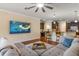 Comfortable living room with a large sectional sofa, ceiling fan, and open access to the kitchen at 19409 Wingrove Ln, Lutz, FL 33558