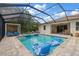 Relaxing screened-in pool with spa, sun loungers, and shaded daybed, perfect for summer enjoyment at 19409 Wingrove Ln, Lutz, FL 33558