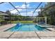 Stunning screened-in pool with an attached spa, outdoor dining area, and a cabana at 19409 Wingrove Ln, Lutz, FL 33558