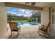 Inviting screened-in pool with lounge chairs for relaxation on the expansive, tiled patio at 19409 Wingrove Ln, Lutz, FL 33558