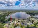 Stunning aerial view of a waterfront property showcasing a well-maintained home and beautiful lake surroundings at 22925 Collridge Dr, Land O Lakes, FL 34639