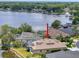 Expansive aerial view of a beautiful home featuring a screened pool and lush landscaping, situated near a picturesque lake at 22925 Collridge Dr, Land O Lakes, FL 34639