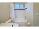 Bright bathroom features a white tiled shower-tub combination and neutral walls at 22925 Collridge Dr, Land O Lakes, FL 34639