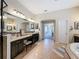 Elegant bathroom with dual vanities, granite countertops, and tile flooring at 22925 Collridge Dr, Land O Lakes, FL 34639