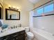 Updated bathroom features a modern vanity with a marble countertop, a framed mirror, and a tub/shower combination at 22925 Collridge Dr, Land O Lakes, FL 34639