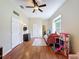 This bedroom has hardwood floors, ceiling fan, and a fun playhouse at 22925 Collridge Dr, Land O Lakes, FL 34639