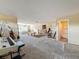 Spacious bonus room with cozy carpet, piano, and access to bedroom and bathroom at 22925 Collridge Dr, Land O Lakes, FL 34639
