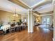 Open-concept dining area boasts hardwood floors, chandelier lighting, and seamless access to living spaces at 22925 Collridge Dr, Land O Lakes, FL 34639