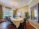 Elegant dining area with hardwood floors, large window, decorative mirror, and ample seating at 22925 Collridge Dr, Land O Lakes, FL 34639