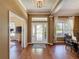Bright foyer featuring hardwood floors, a glass-paneled front door, and views into the dining and living areas at 22925 Collridge Dr, Land O Lakes, FL 34639