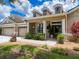 Inviting single-Gathering home features a three-car garage, dormer windows, and a charming front porch at 22925 Collridge Dr, Land O Lakes, FL 34639
