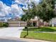 Charming single-story home boasts a well-manicured lawn, mature trees, and a spacious three-car garage at 22925 Collridge Dr, Land O Lakes, FL 34639