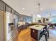Well-lit kitchen features stainless steel appliances, an island with seating, and dark cabinetry at 22925 Collridge Dr, Land O Lakes, FL 34639