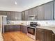 Spacious kitchen with stainless steel appliances and stylish dark wood cabinetry at 22925 Collridge Dr, Land O Lakes, FL 34639