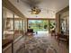 The covered lanai provides a relaxing space with an area rug, ceiling fan, and a view of the pool and backyard at 22925 Collridge Dr, Land O Lakes, FL 34639
