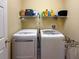 Functional laundry room with modern washer and dryer, and convenient storage space at 22925 Collridge Dr, Land O Lakes, FL 34639