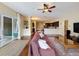 Open-plan living room with hardwood floors, access to the kitchen and outdoor patio at 22925 Collridge Dr, Land O Lakes, FL 34639