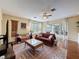 Bright living room featuring hardwood floors, a ceiling fan, and access to the patio at 22925 Collridge Dr, Land O Lakes, FL 34639